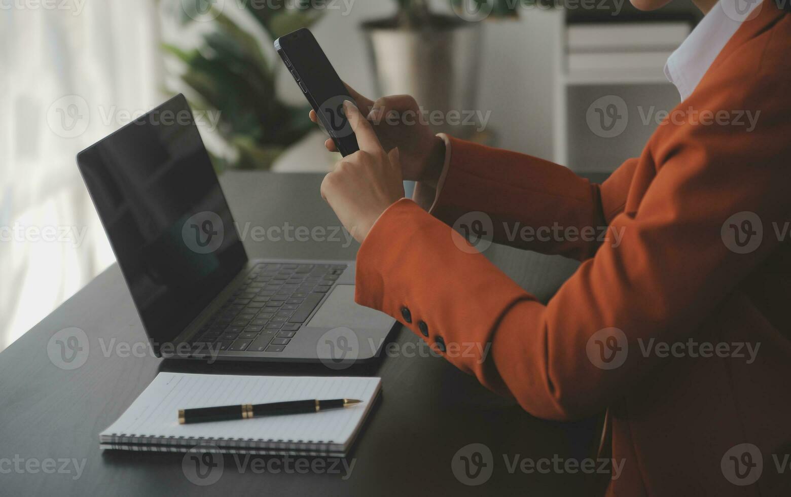 Asian Business woman using calculator and laptop for doing math finance on an office desk, tax, report, accounting, statistics, and analytical research concept photo