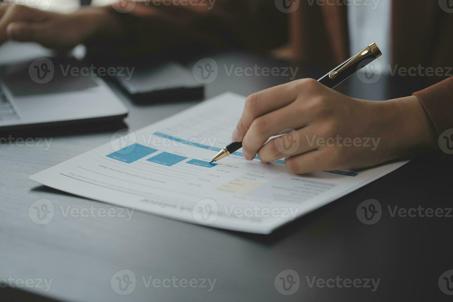 Asian Business woman using calculator and laptop for doing math finance on an office desk, tax, report, accounting, statistics, and analytical research concept photo