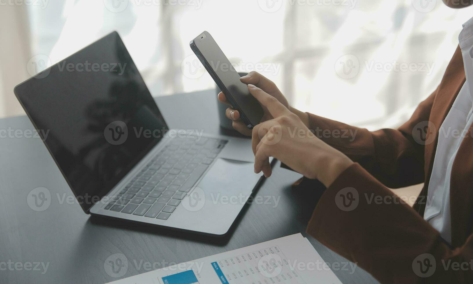 Asian Business woman using calculator and laptop for doing math finance on an office desk, tax, report, accounting, statistics, and analytical research concept photo