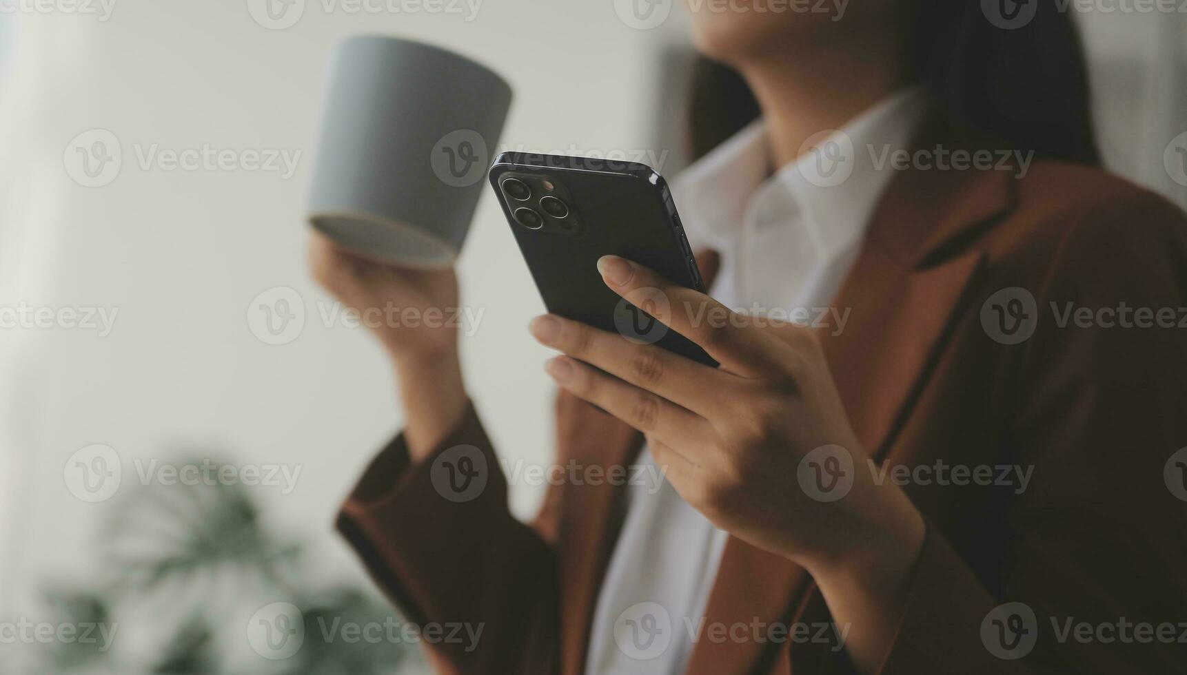 Asian Business woman using calculator and laptop for doing math finance on an office desk, tax, report, accounting, statistics, and analytical research concept photo