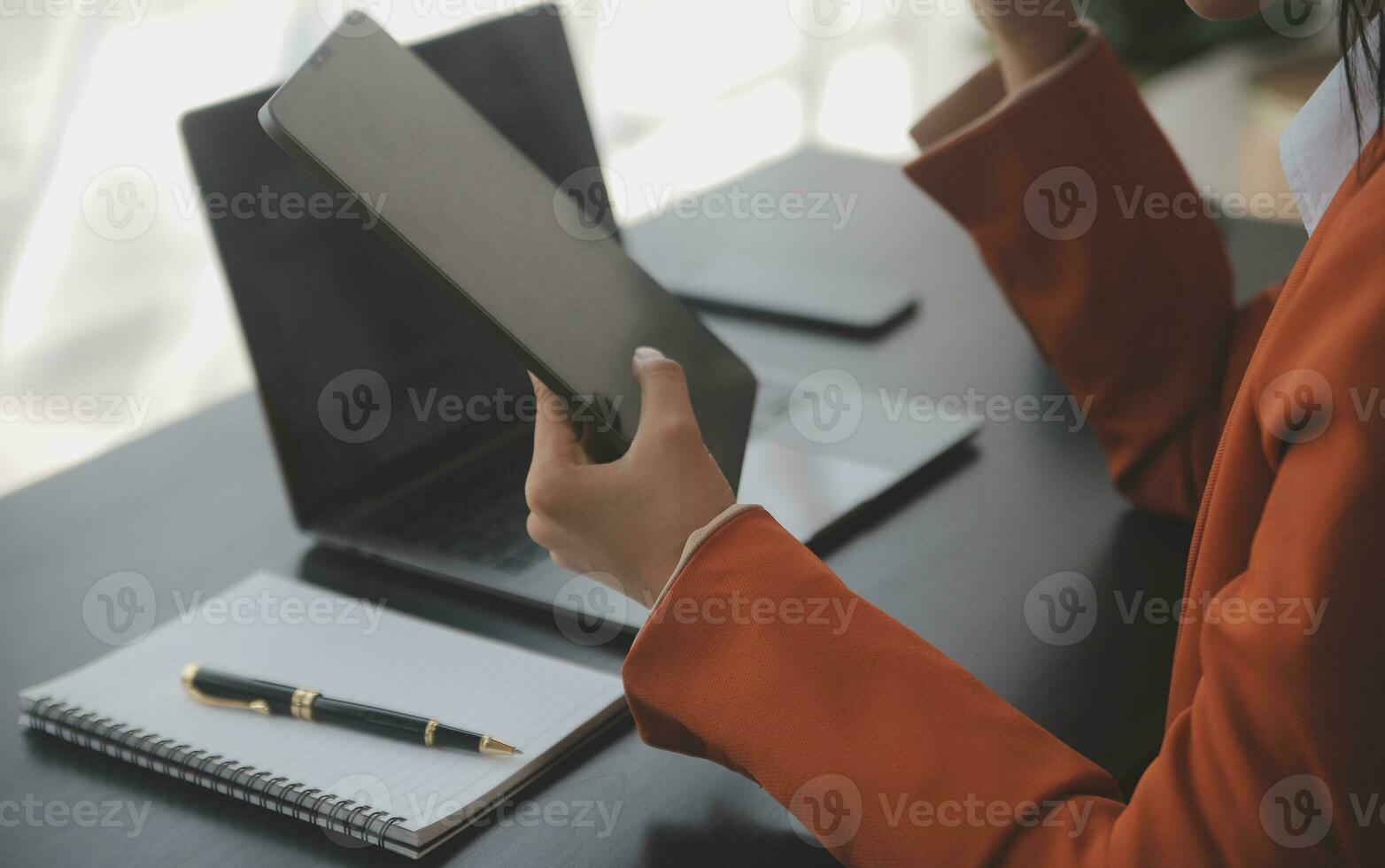 Asian Business woman using calculator and laptop for doing math finance on an office desk, tax, report, accounting, statistics, and analytical research concept photo