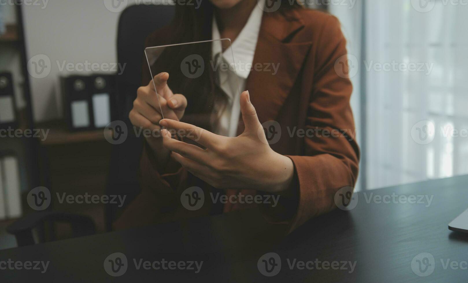 Portrait of Young Asian woman hand freelancer is working her job on computer tablet in modern office. Doing accounting analysis report real estate investment data, Financial and tax systems concept. photo