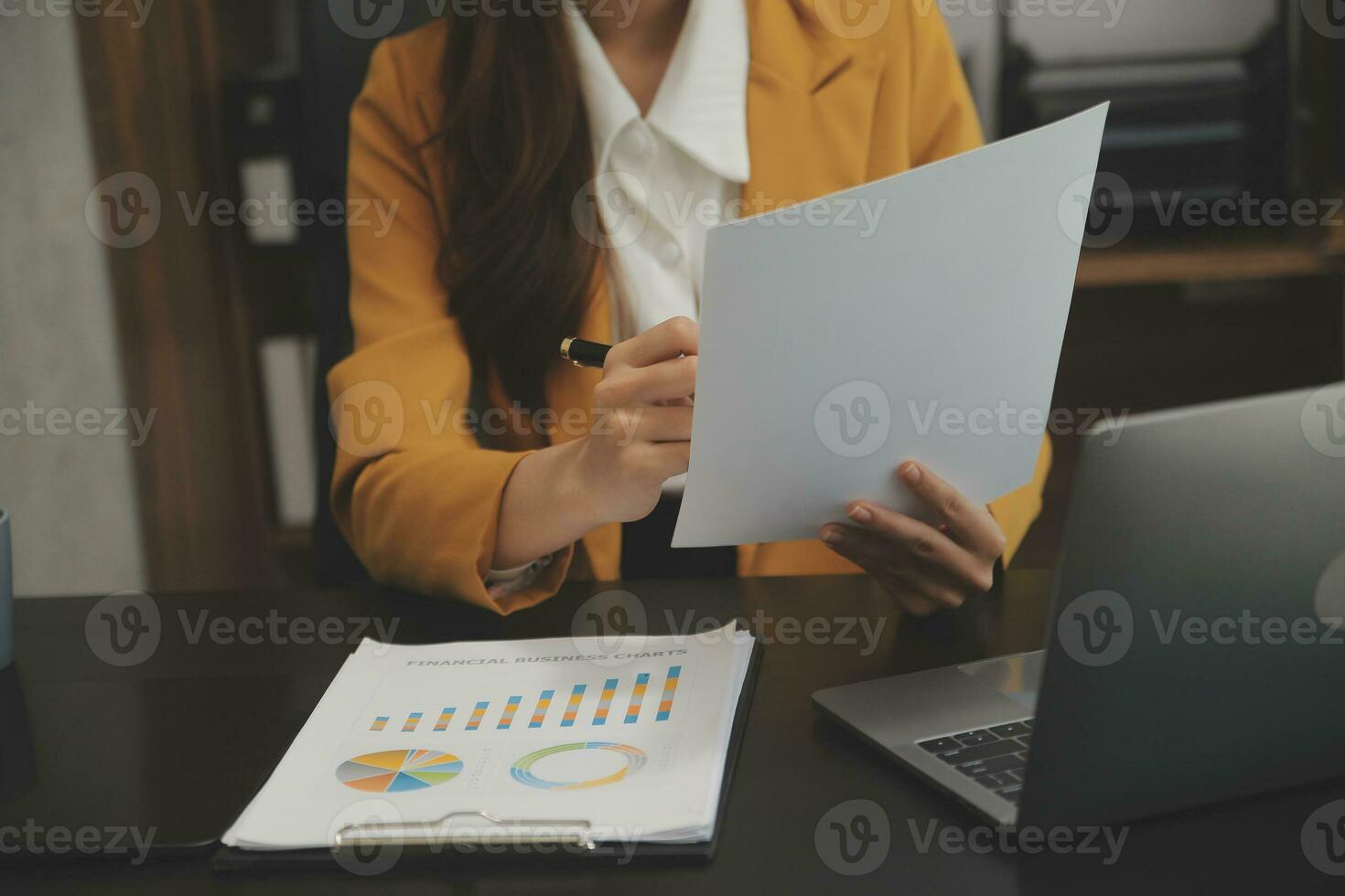Portrait of Young Asian woman hand freelancer is working her job on computer tablet in modern office. Doing accounting analysis report real estate investment data, Financial and tax systems concept. photo