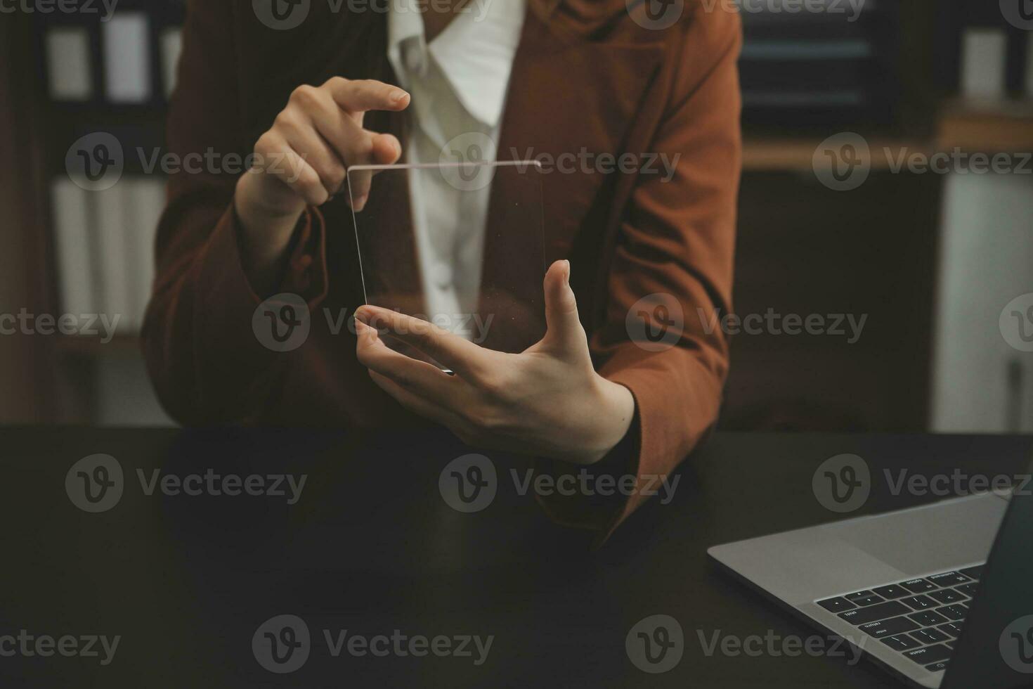 Portrait of Young Asian woman hand freelancer is working her job on computer tablet in modern office. Doing accounting analysis report real estate investment data, Financial and tax systems concept. photo