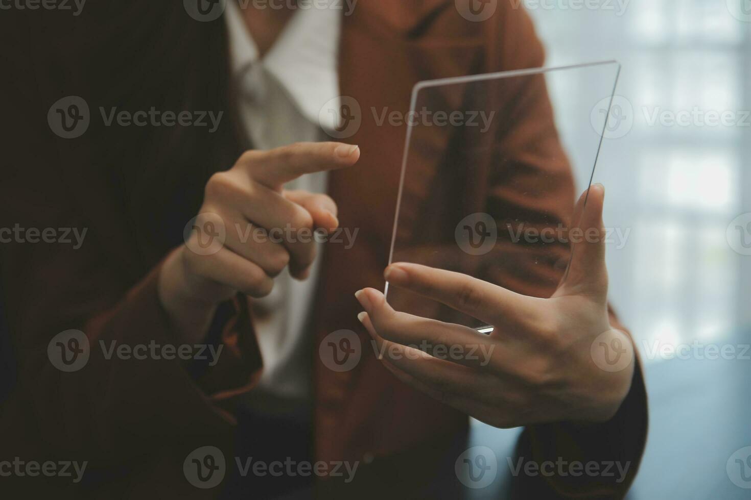 Portrait of Young Asian woman hand freelancer is working her job on computer tablet in modern office. Doing accounting analysis report real estate investment data, Financial and tax systems concept. photo