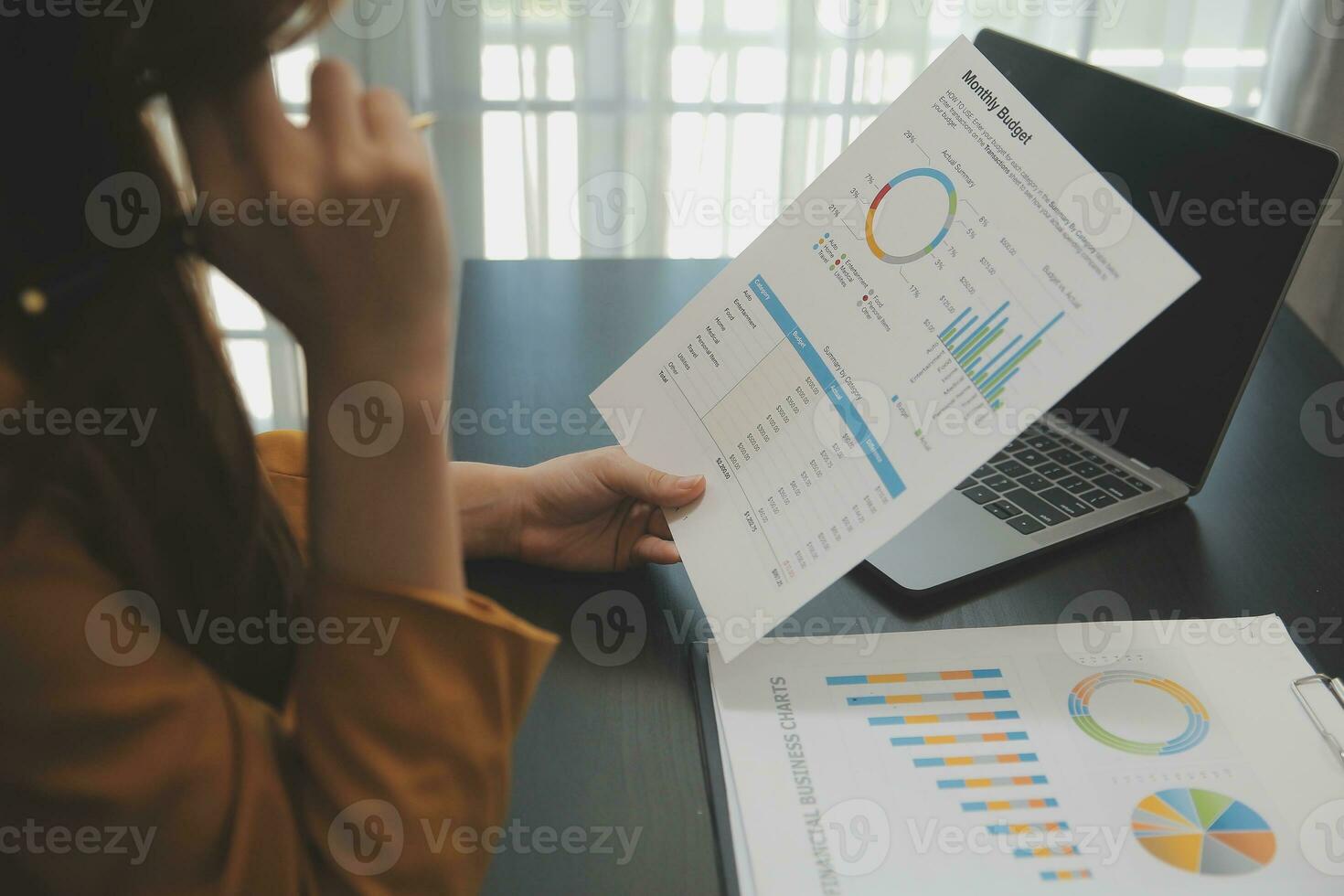 Portrait of Young Asian woman hand freelancer is working her job on computer tablet in modern office. Doing accounting analysis report real estate investment data, Financial and tax systems concept. photo