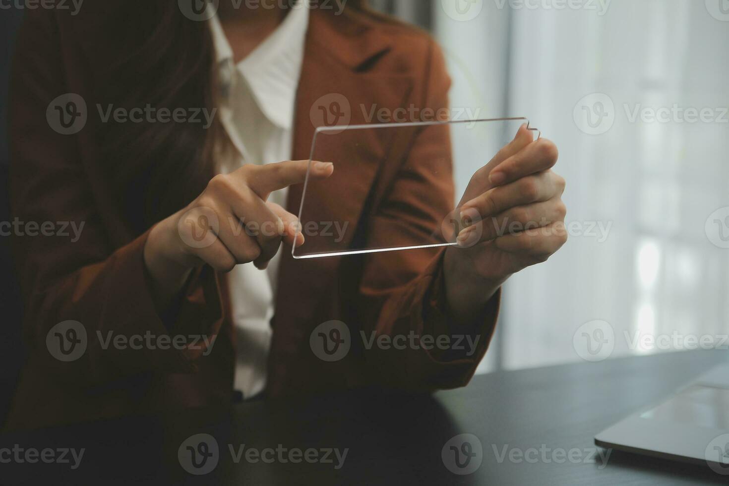 Portrait of Young Asian woman hand freelancer is working her job on computer tablet in modern office. Doing accounting analysis report real estate investment data, Financial and tax systems concept. photo