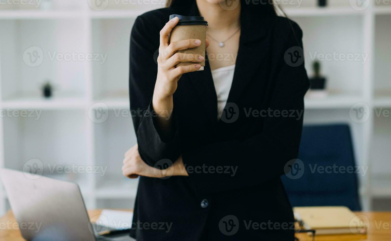 Asian Business woman using calculator and laptop for doing math finance on an office desk, tax, report, accounting, statistics, and analytical research concept photo