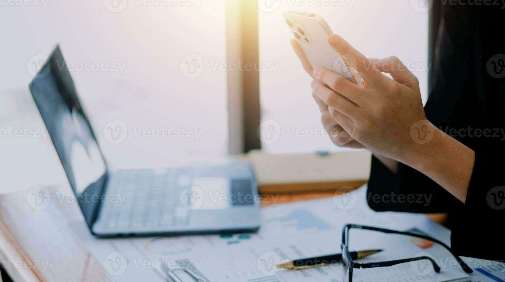 Asian Business woman using calculator and laptop for doing math finance on an office desk, tax, report, accounting, statistics, and analytical research concept photo