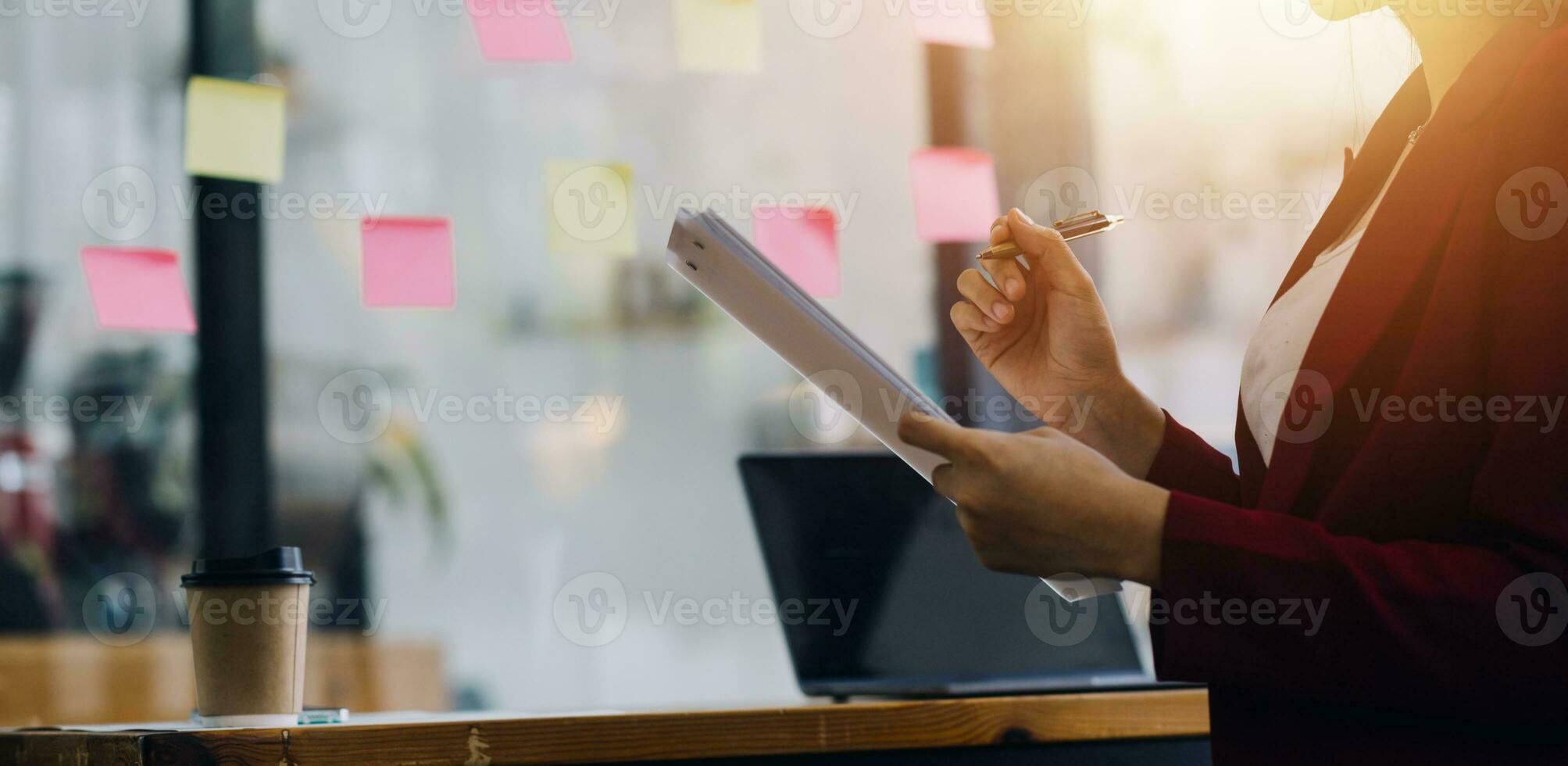 Asian Business woman using calculator and laptop for doing math finance on an office desk, tax, report, accounting, statistics, and analytical research concept photo
