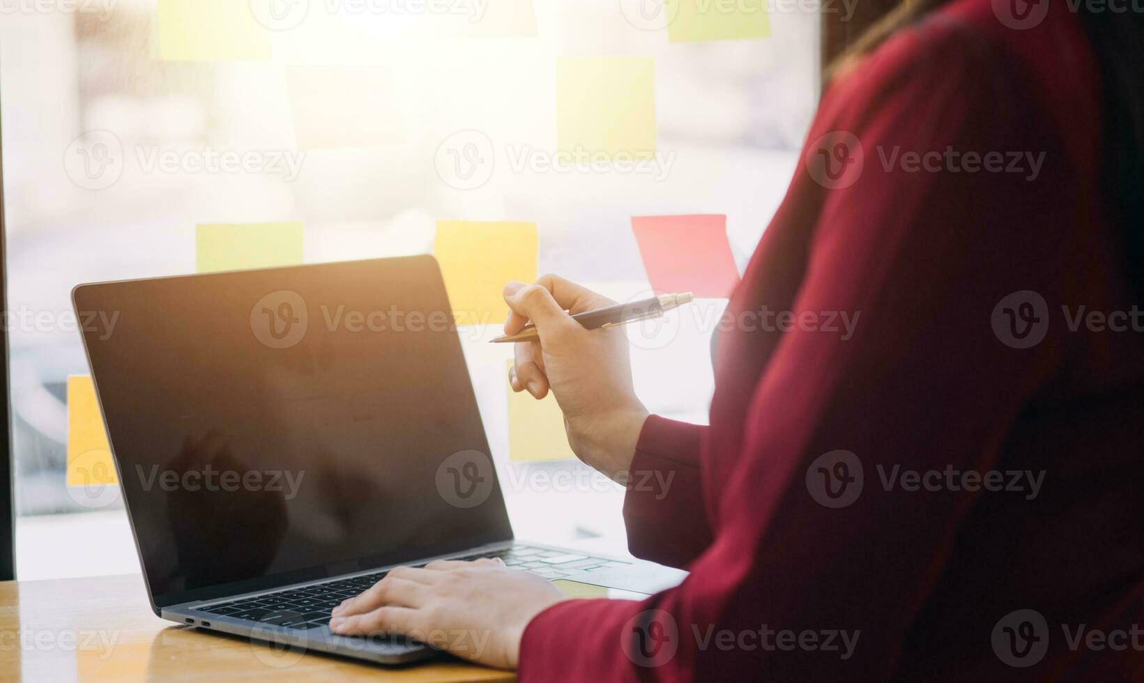 Asian Business woman using calculator and laptop for doing math finance on an office desk, tax, report, accounting, statistics, and analytical research concept photo