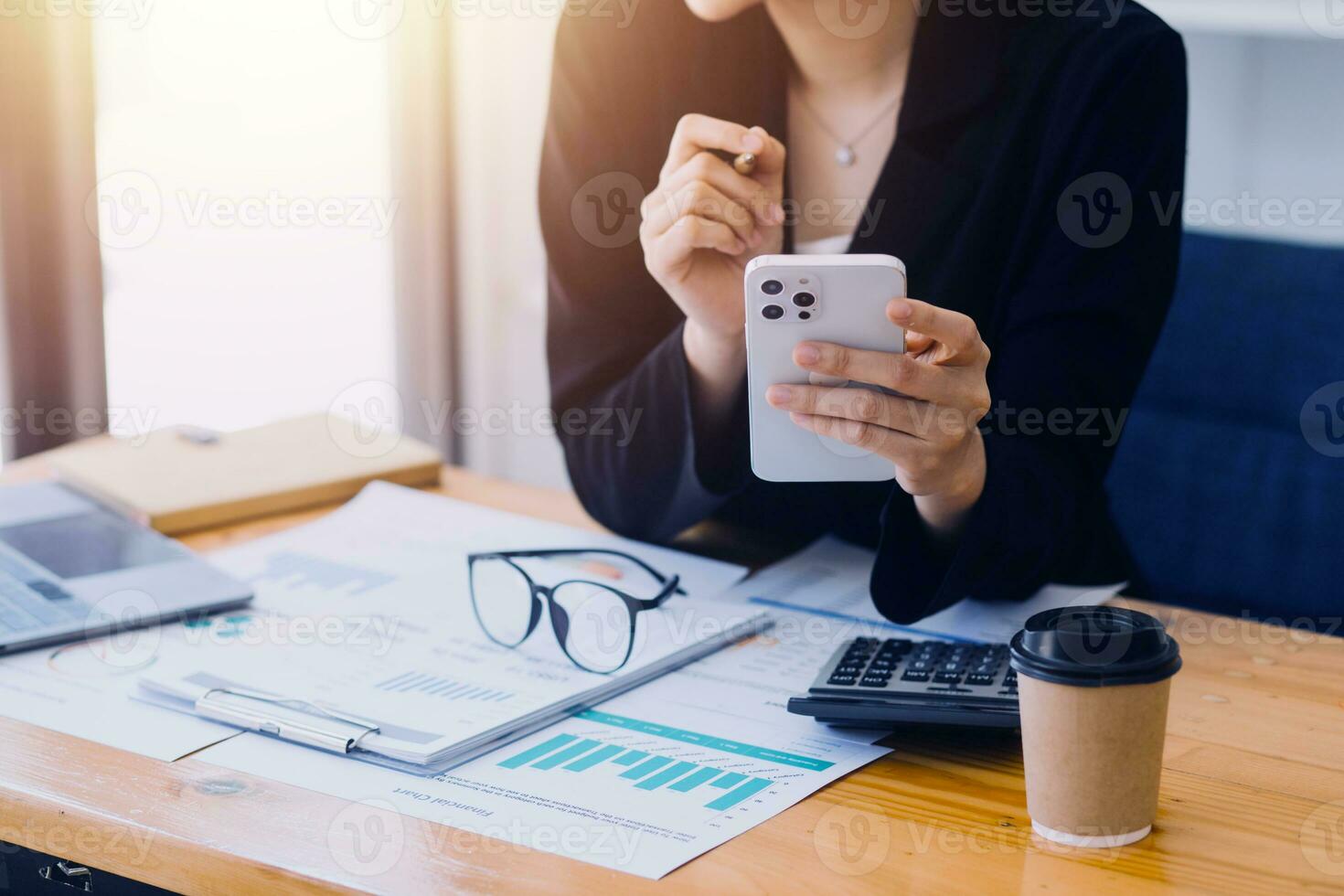 Asian Business woman using calculator and laptop for doing math finance on an office desk, tax, report, accounting, statistics, and analytical research concept photo