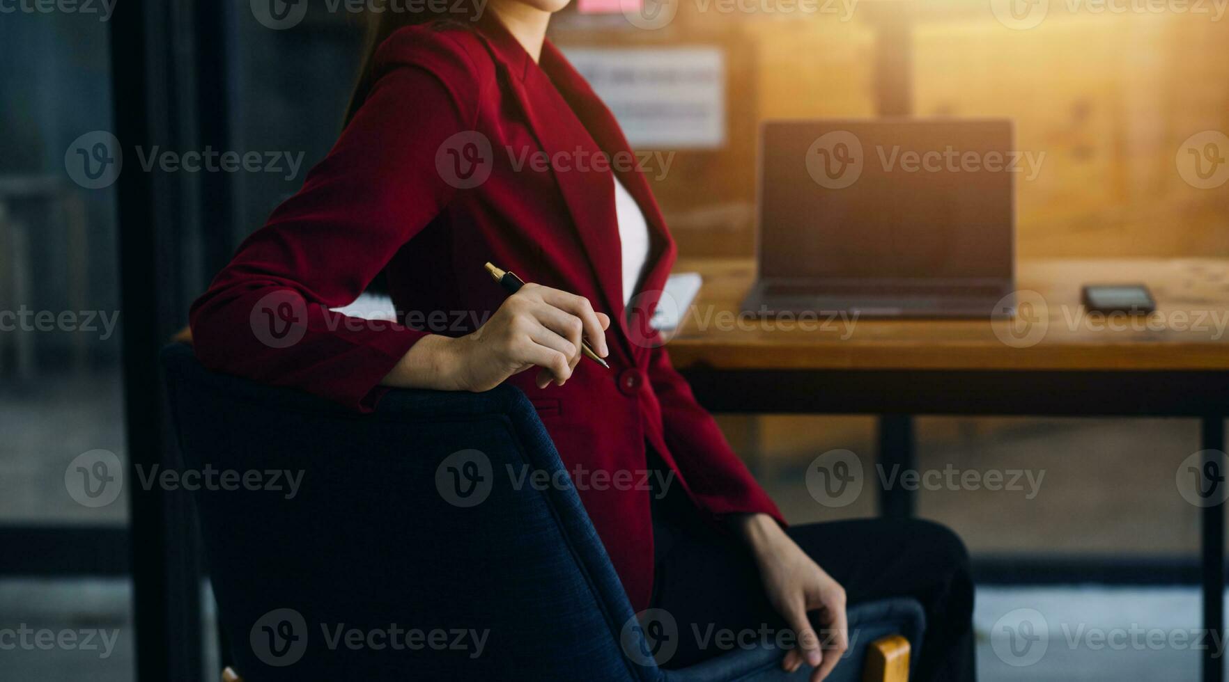 Asian Business woman using calculator and laptop for doing math finance on an office desk, tax, report, accounting, statistics, and analytical research concept photo