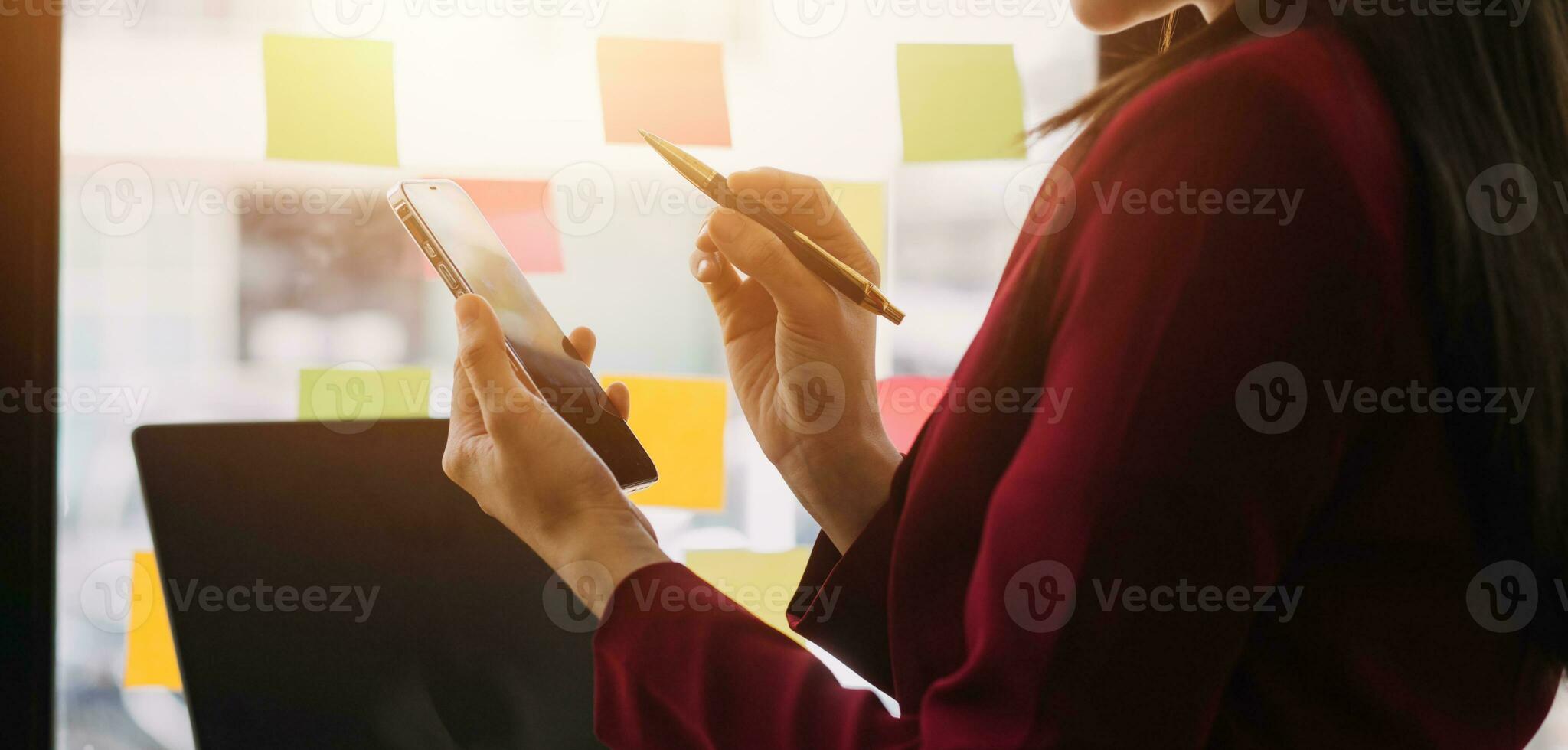 Asian Business woman using calculator and laptop for doing math finance on an office desk, tax, report, accounting, statistics, and analytical research concept photo