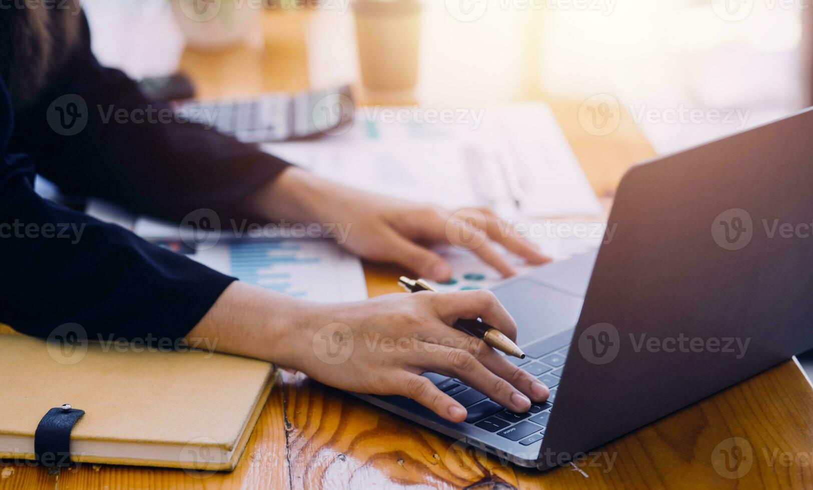 Asian Business woman using calculator and laptop for doing math finance on an office desk, tax, report, accounting, statistics, and analytical research concept photo