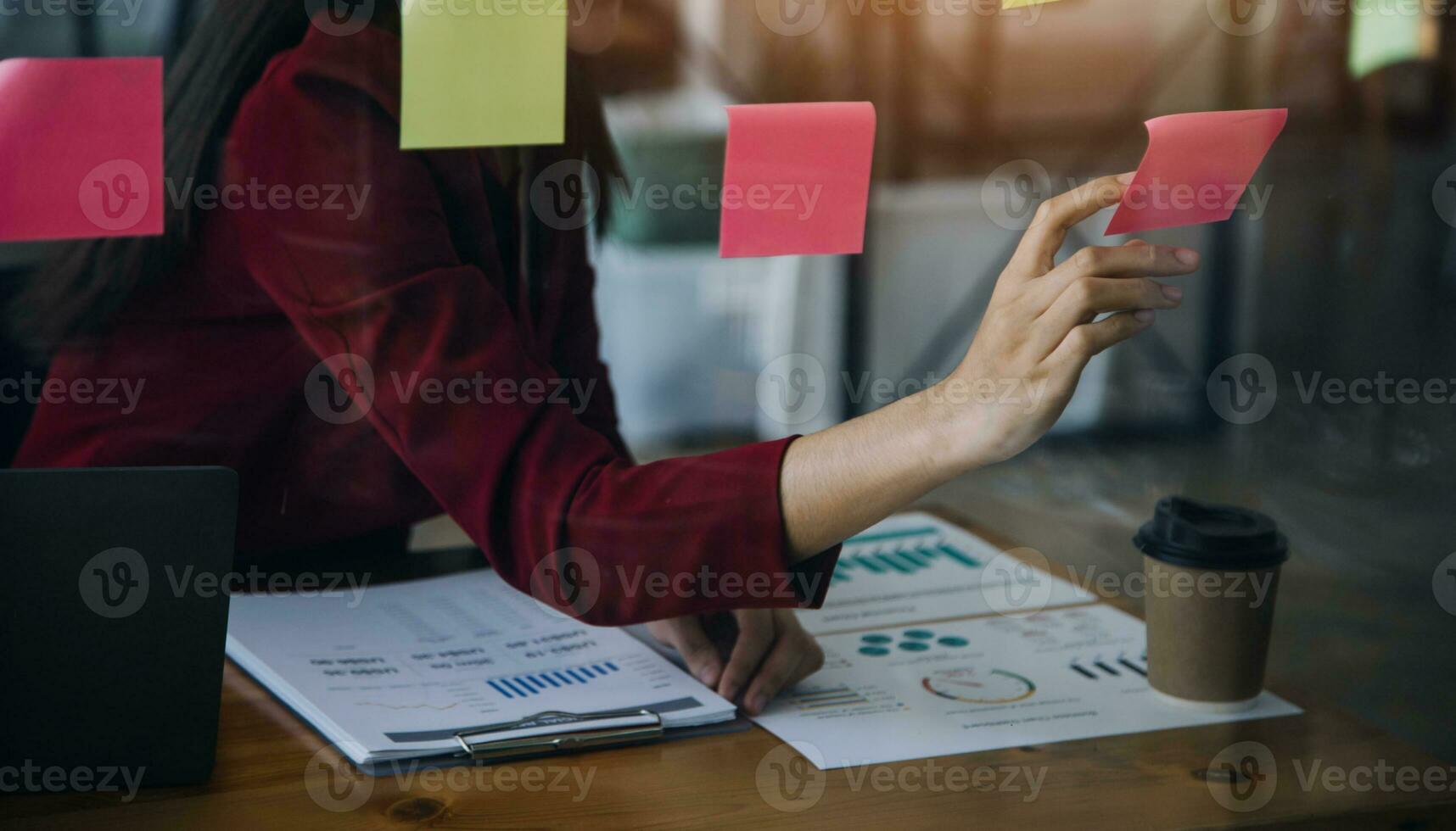 Asian Business woman using calculator and laptop for doing math finance on an office desk, tax, report, accounting, statistics, and analytical research concept photo