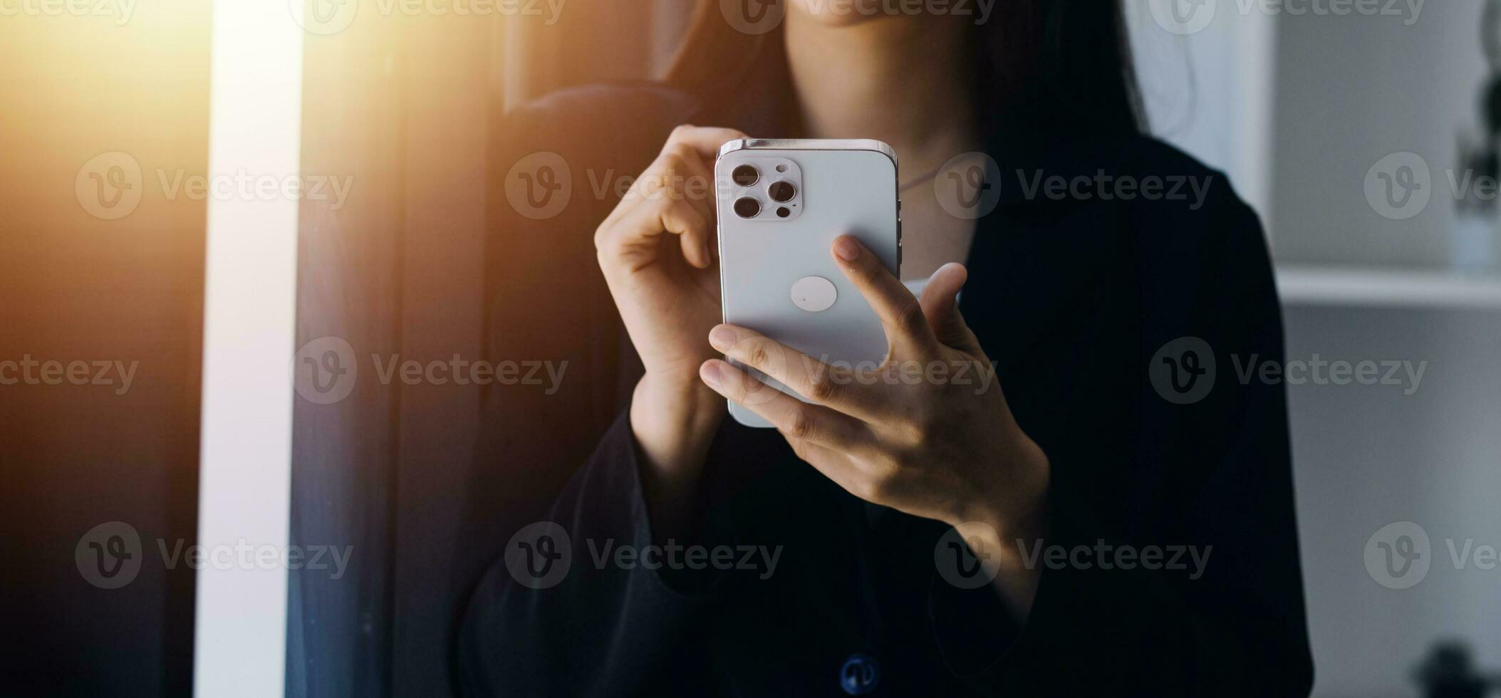 Asian Business woman using calculator and laptop for doing math finance on an office desk, tax, report, accounting, statistics, and analytical research concept photo