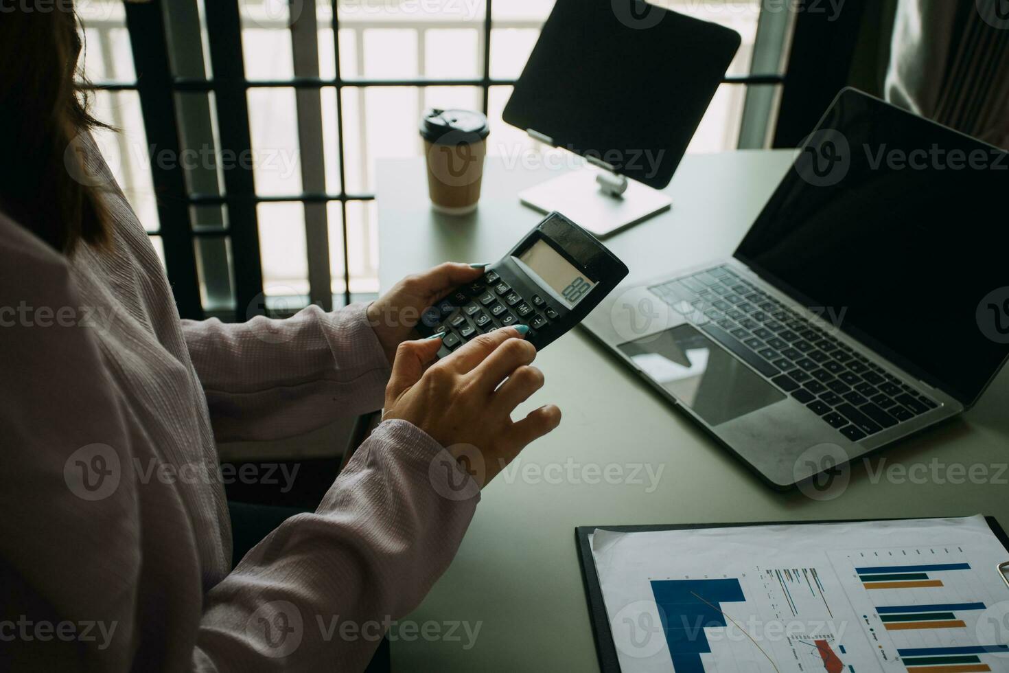 Creative Asian young woman working on laptop in her studio photo