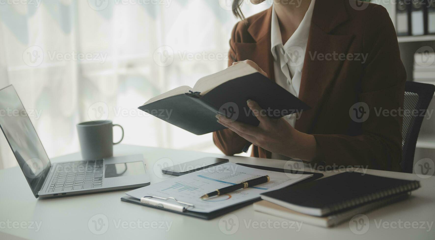 Beautiful female call center operator working on computer in office photo
