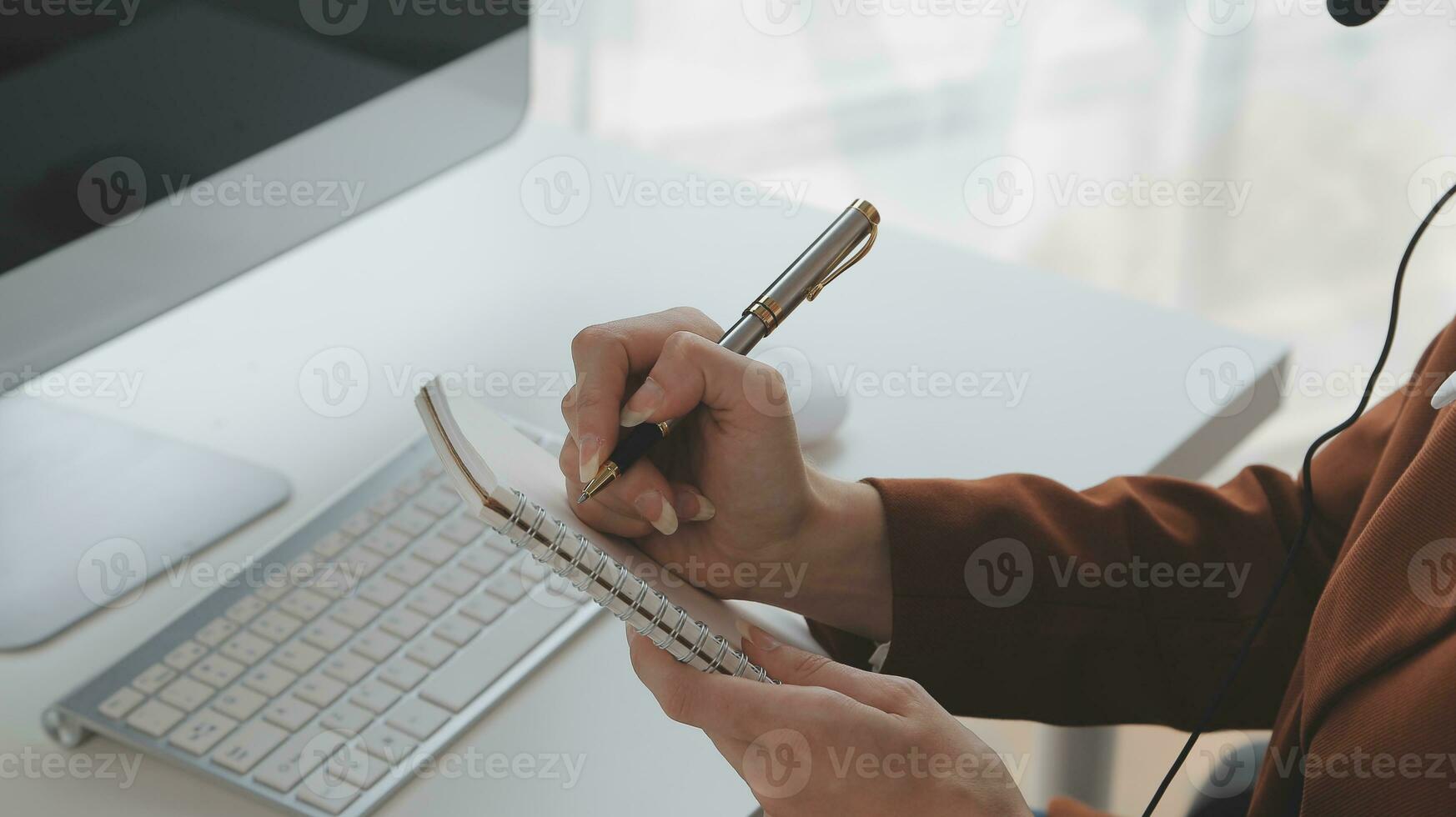 Beautiful female call center operator working on computer in office photo
