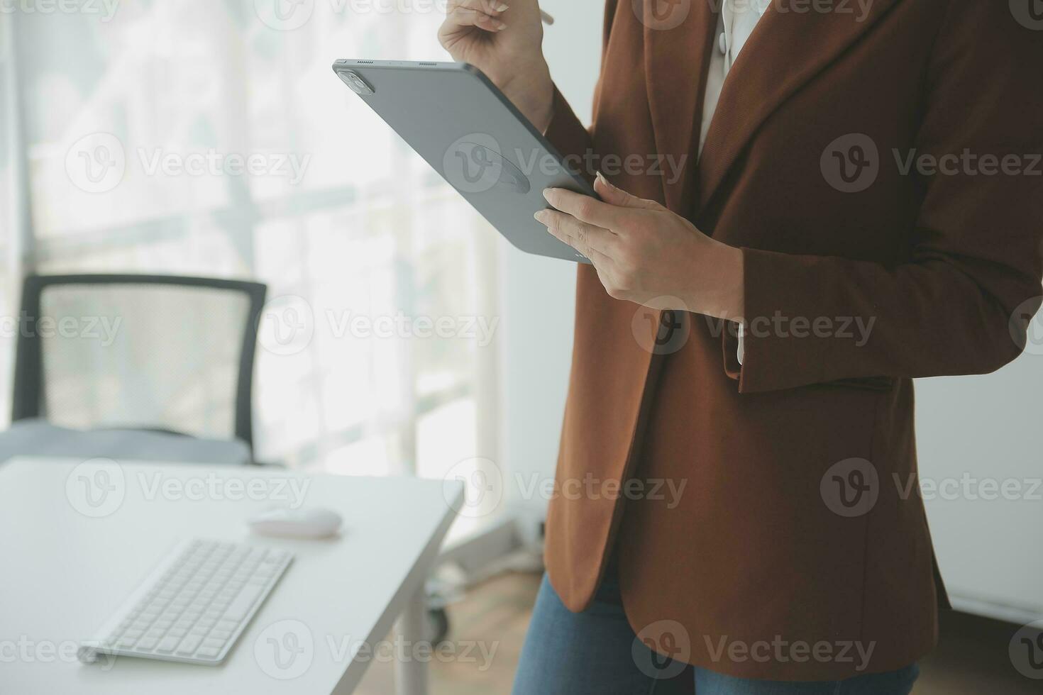 Beautiful female call center operator working on computer in office photo