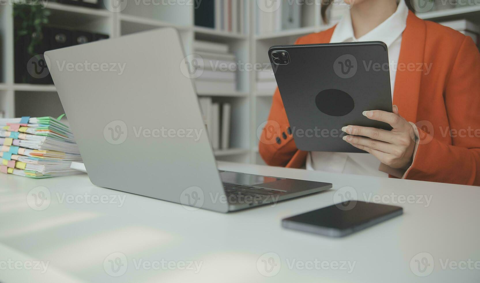 Beautiful female call center operator working on computer in office photo