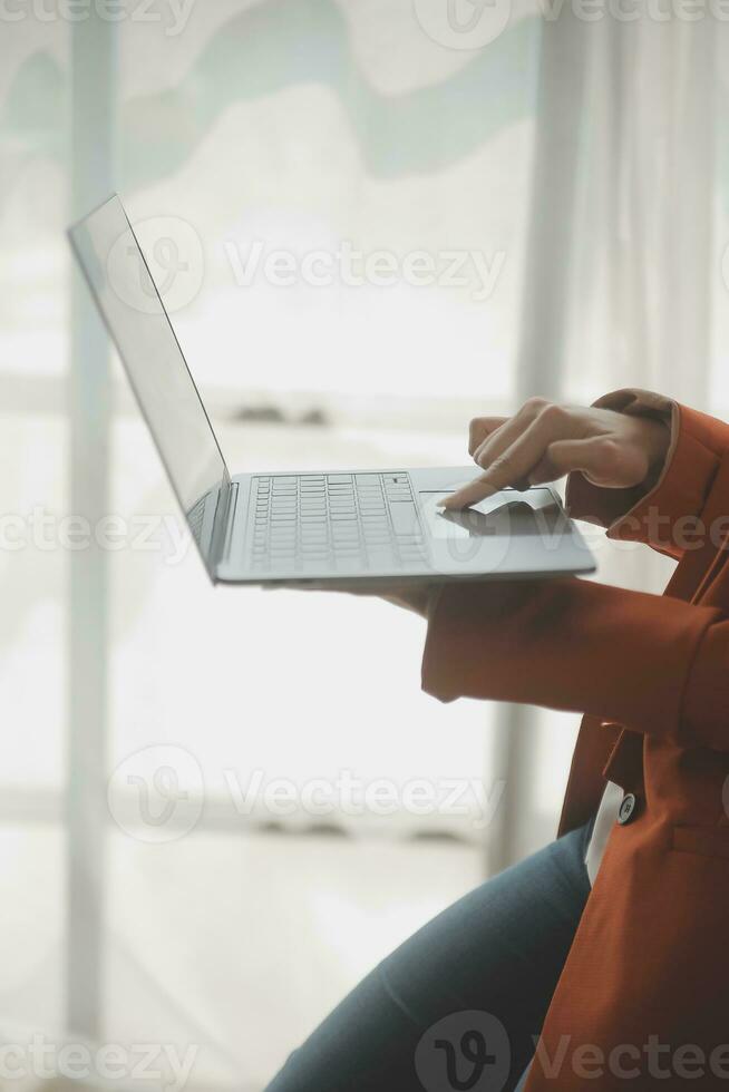 Close up Business woman using calculator and laptop for do math finance on wooden desk, tax, accounting, statistics and analytical research concept photo