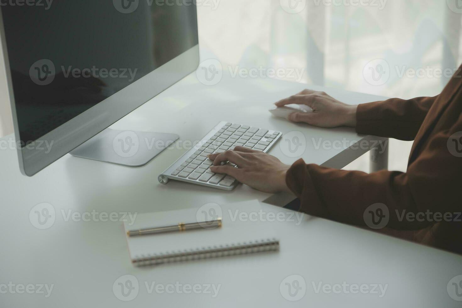 Portrait of Young Asian woman hand freelancer is working her job on computer tablet in modern office. Doing accounting analysis report real estate investment data, Financial and tax systems concept. photo