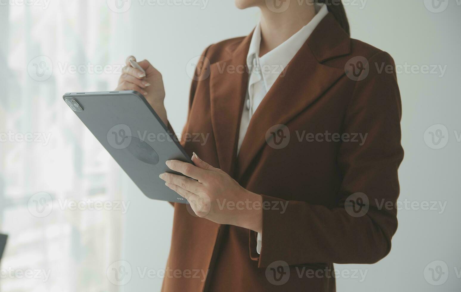 Beautiful female call center operator working on computer in office photo