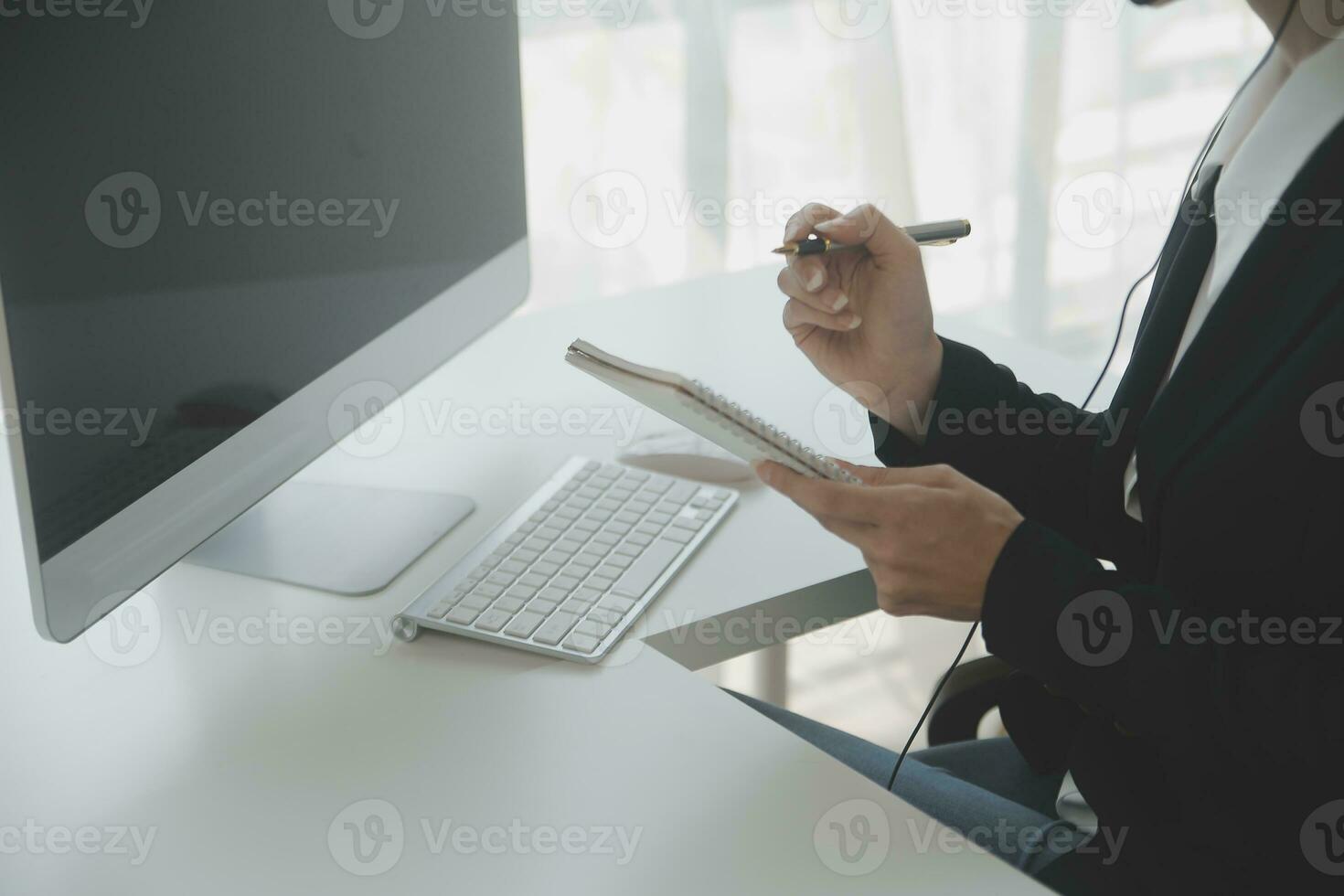 Beautiful female call center operator working on computer in office photo