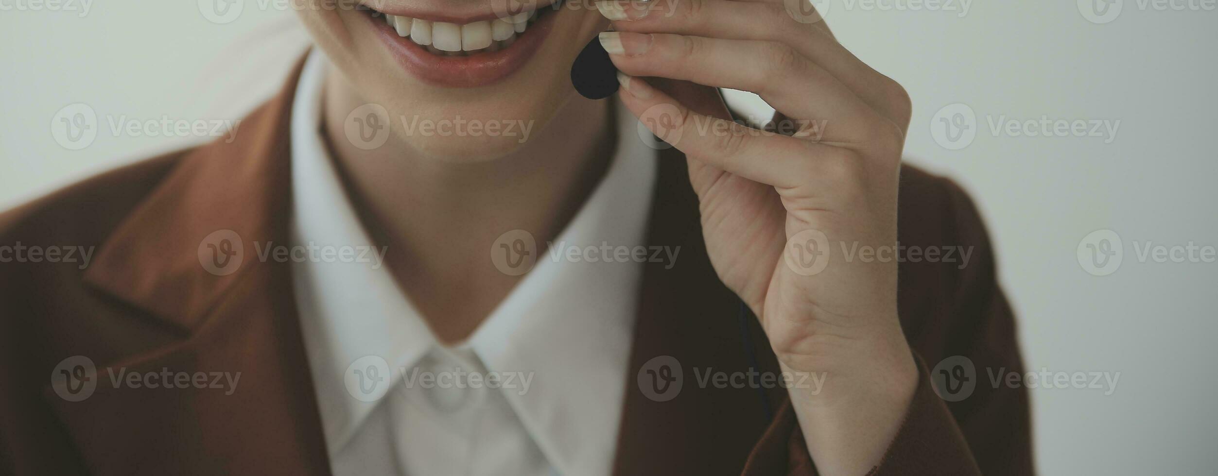Beautiful female call center operator working on computer in office photo