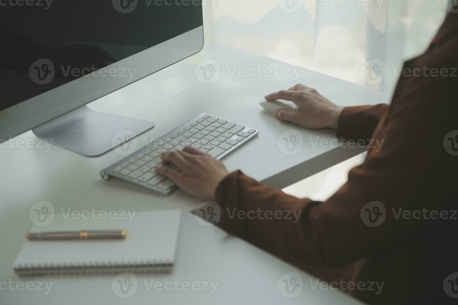 Beautiful female call center operator working on computer in office photo