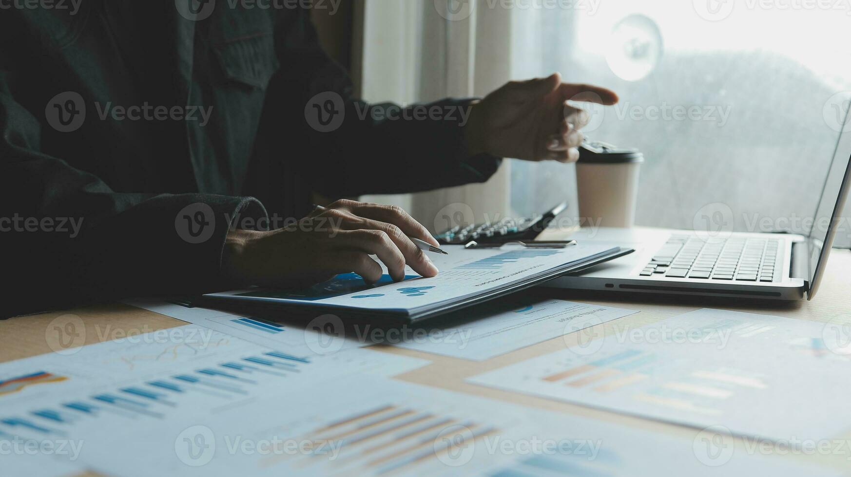 Close up businessman hand using calculator and working with laptop calculate about finance accounting at coffeeshop outdor.finance accounting concept photo