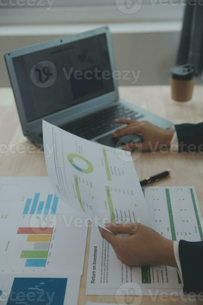 Portrait of Young Asian woman hand freelancer is working her job on computer tablet in modern office. Doing accounting analysis report real estate investment data, Financial and tax systems concept. photo