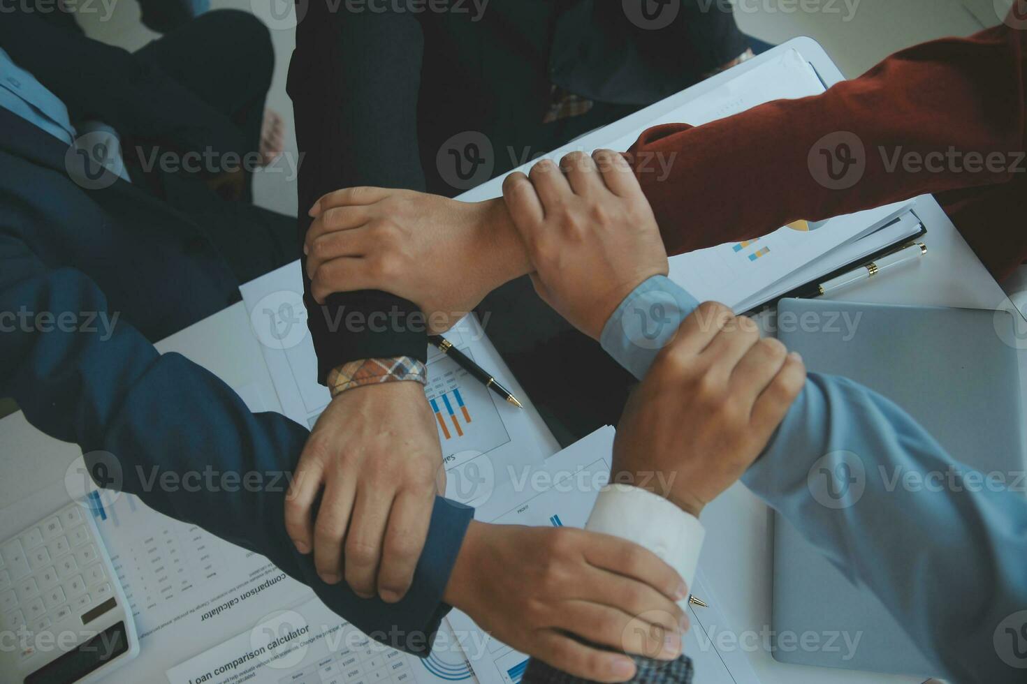 Large business team showing unity with their hands together photo