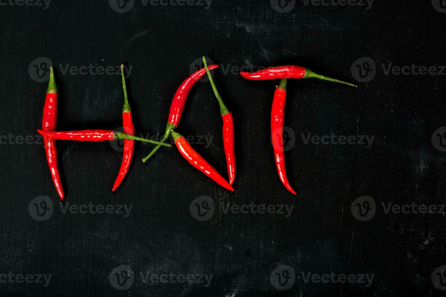 Fresh hot chili pepper on a wooden surface. photo