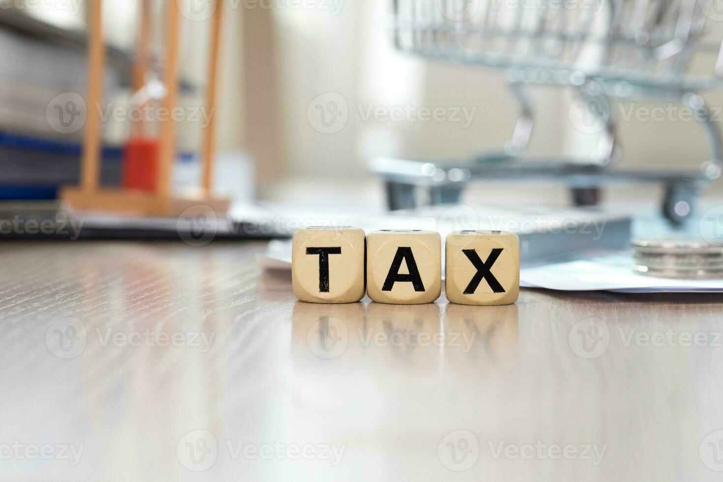 Word TAX composed of wooden letters. Closeup photo