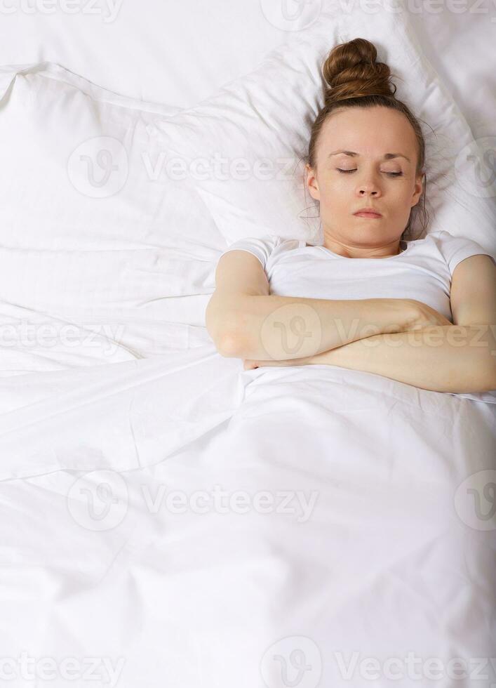 Young lady stays in her bed. Closeup photo