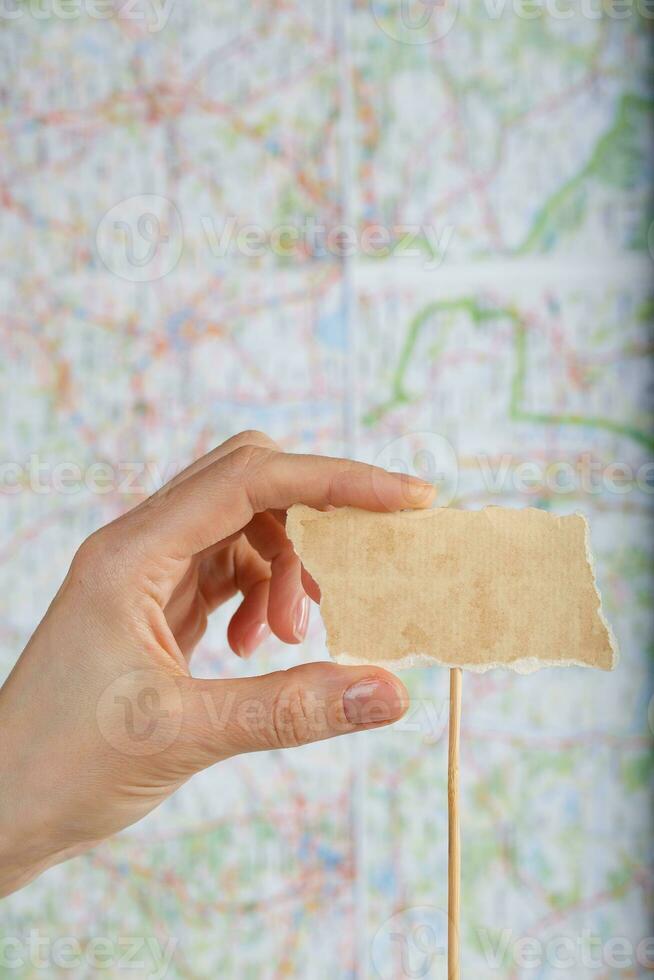 Piece of paper with free space for a text on a map. photo