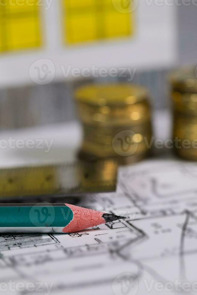 Coal pencil and metal ruler on a technical drawing of an apartment. photo