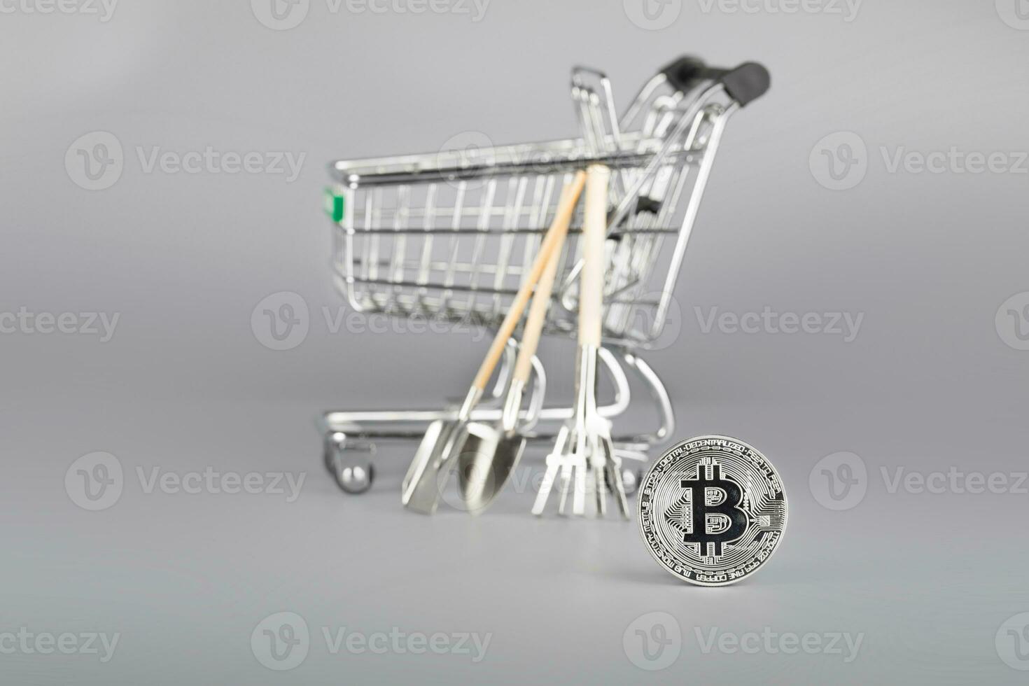 Bitcoin and shopping cart with tools in the background. photo
