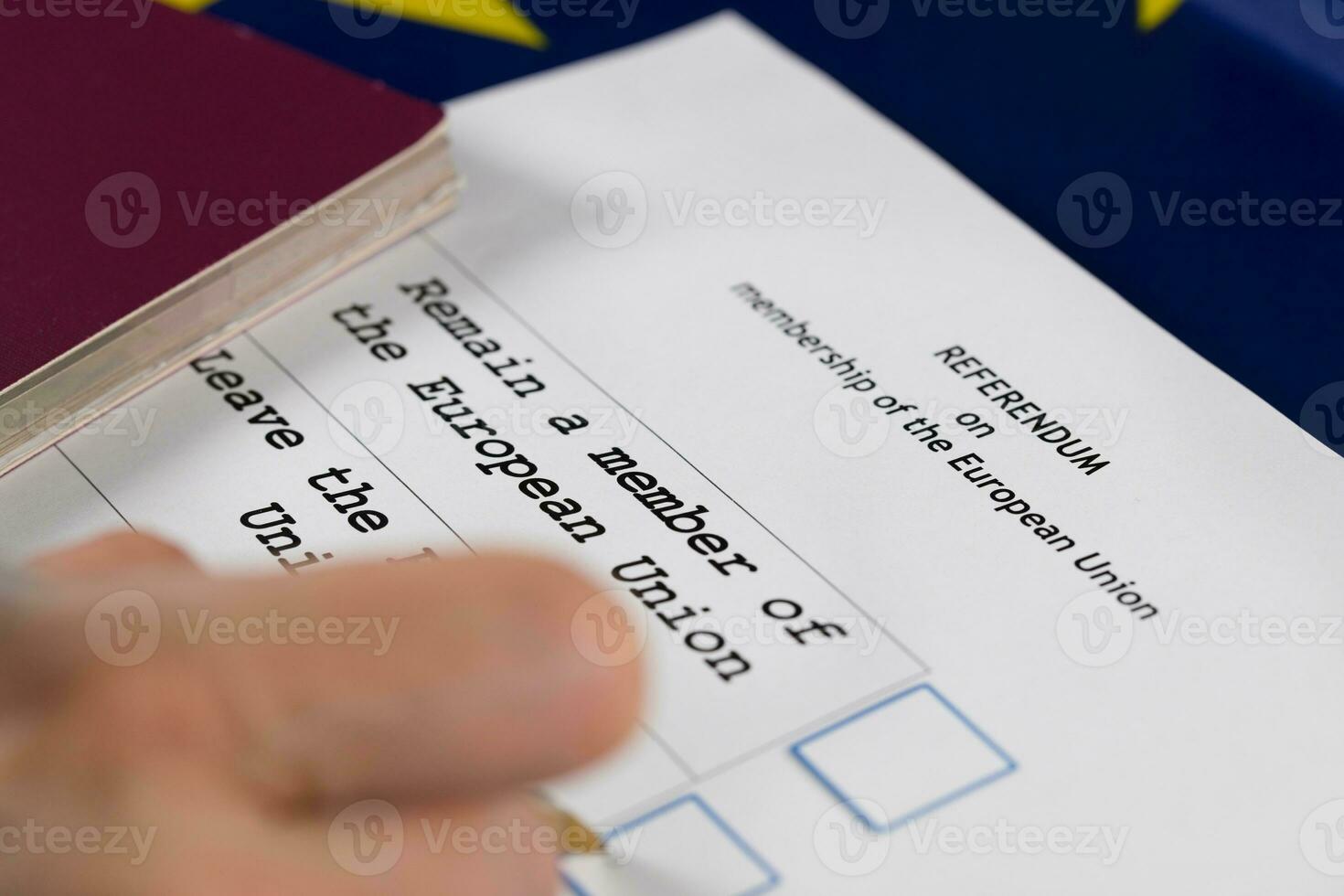 EU Referendum ballot paper, black pen, and passport on the table. photo