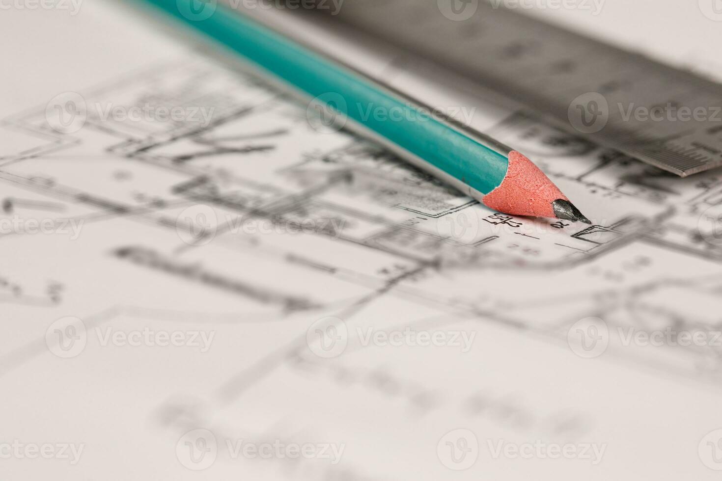 Coal pencil and metal ruler on a technical drawing of an apartment. photo