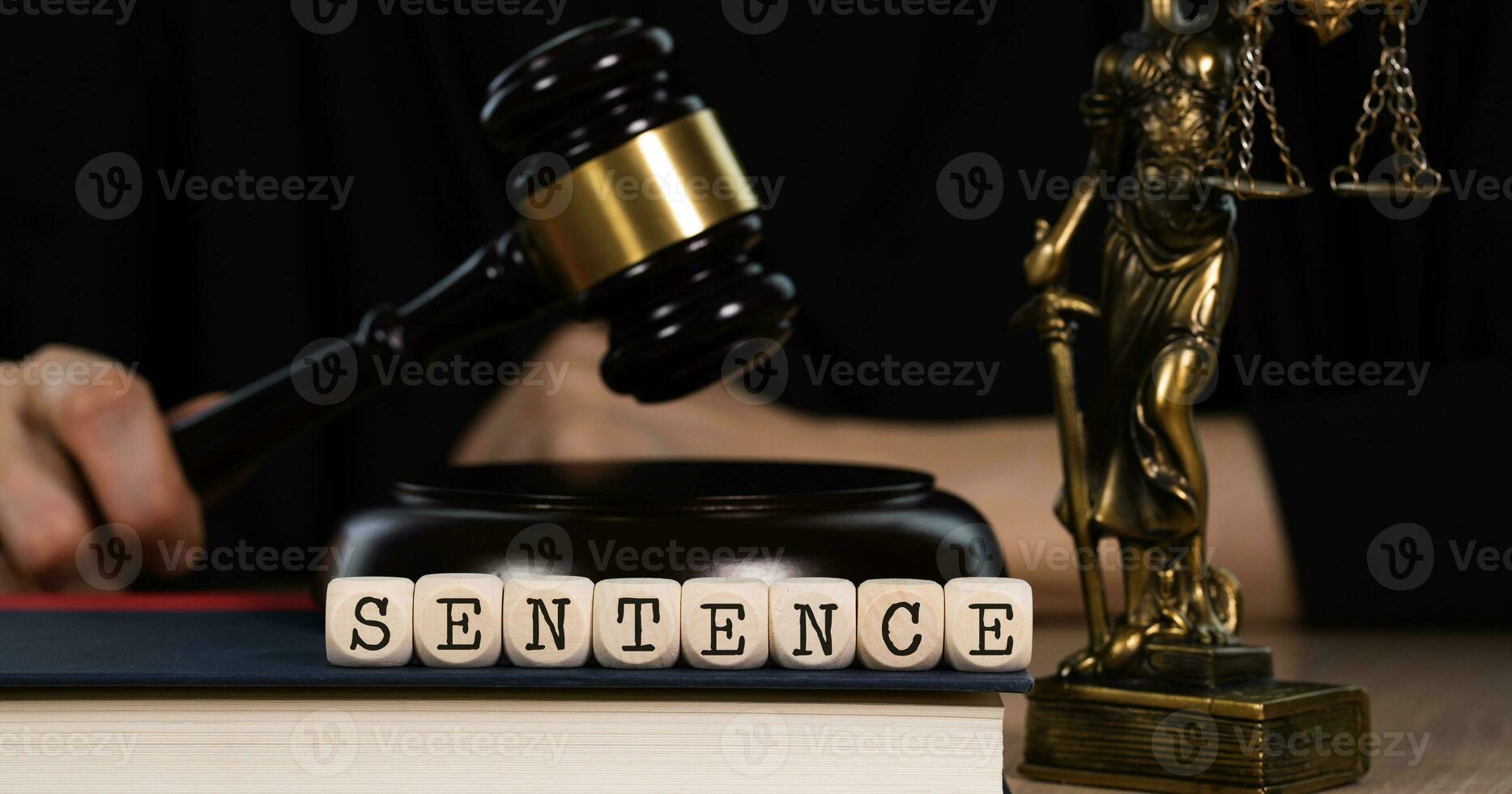 Word SENTENCE composed of wooden dices. Wooden gavel and statue of Themis in the background. photo
