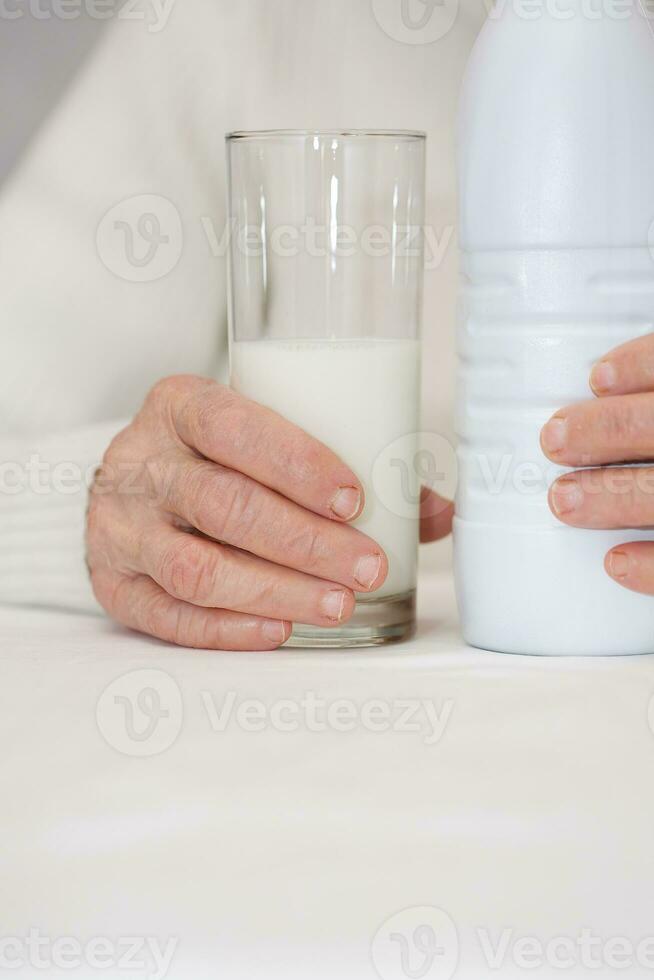 Senior woman and a glass of milk. photo