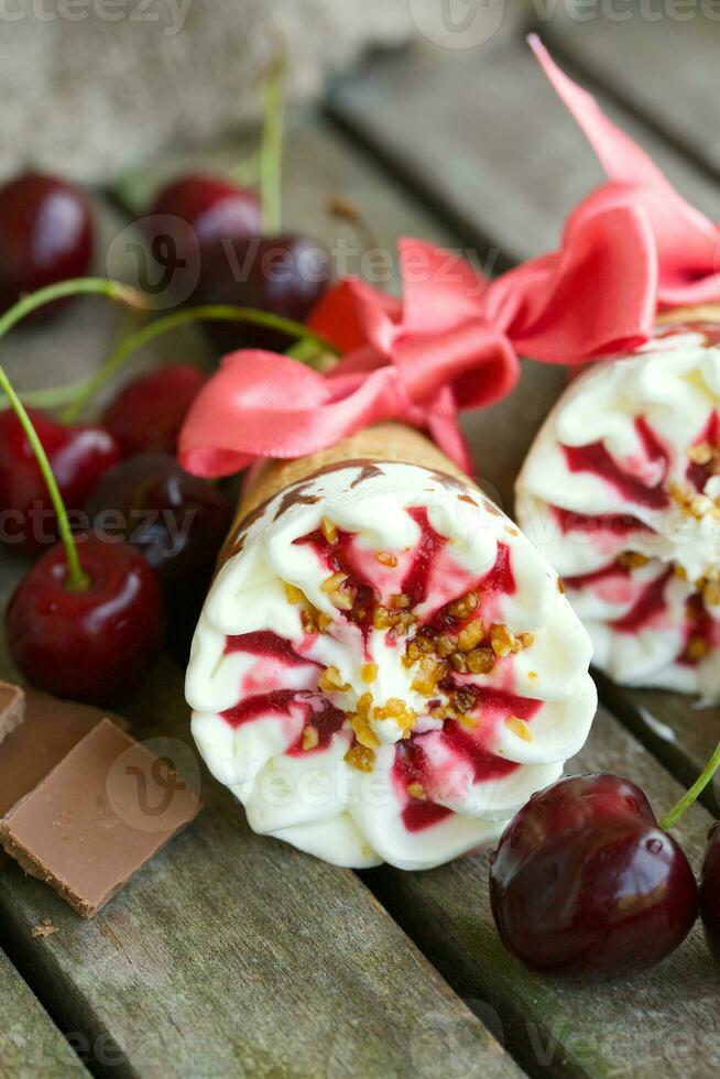 Cherry vanilla ice-cream with caramel topping. Closeup photo