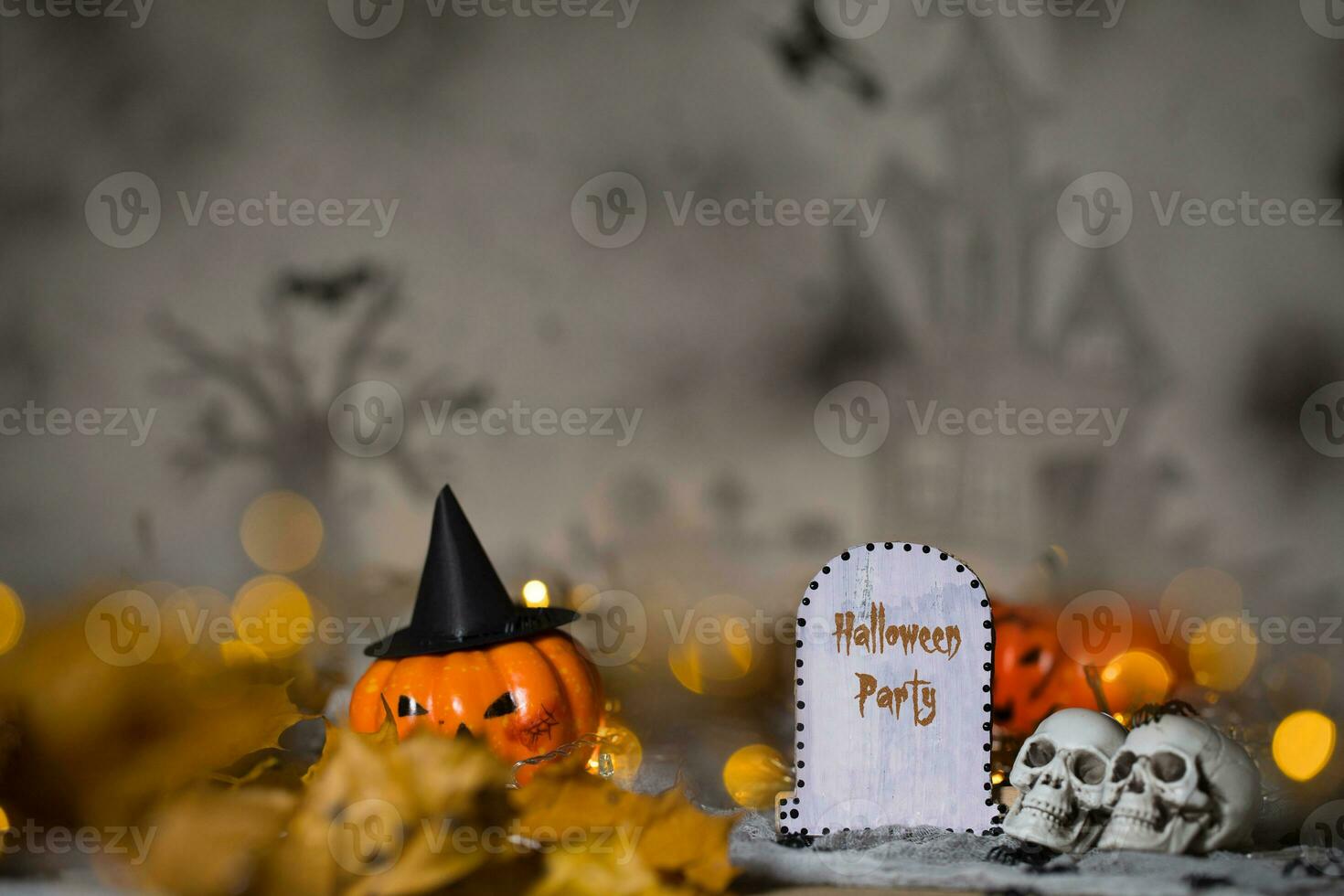 Halloween Party. Grave and two skulls. Closeup photo