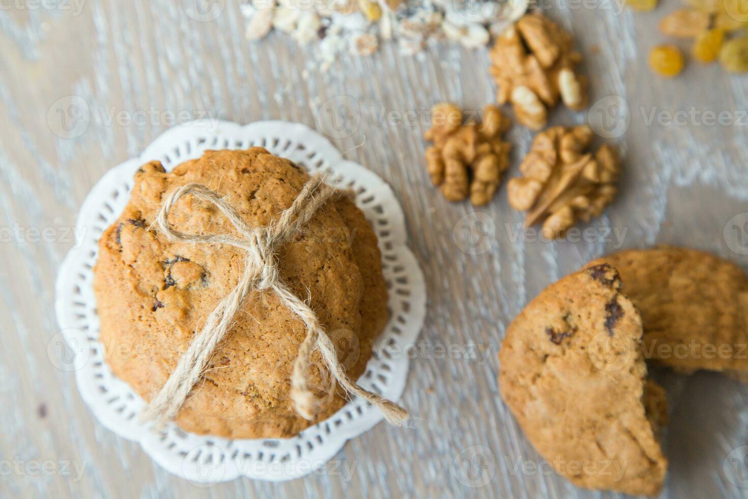 Three oat biscuits with raisins and wallnuts photo