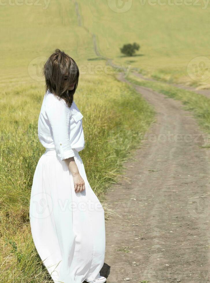 Young caucasian lady between 30 and 35 years old in the field photo