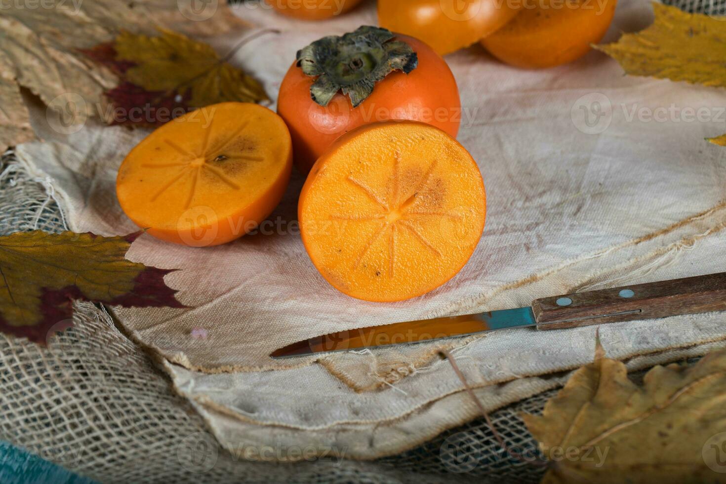 Persimmon fruit on a sackcloth. photo